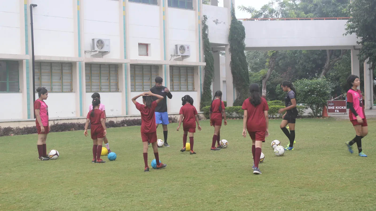 Girls playing football together at a She Kicks community session in India