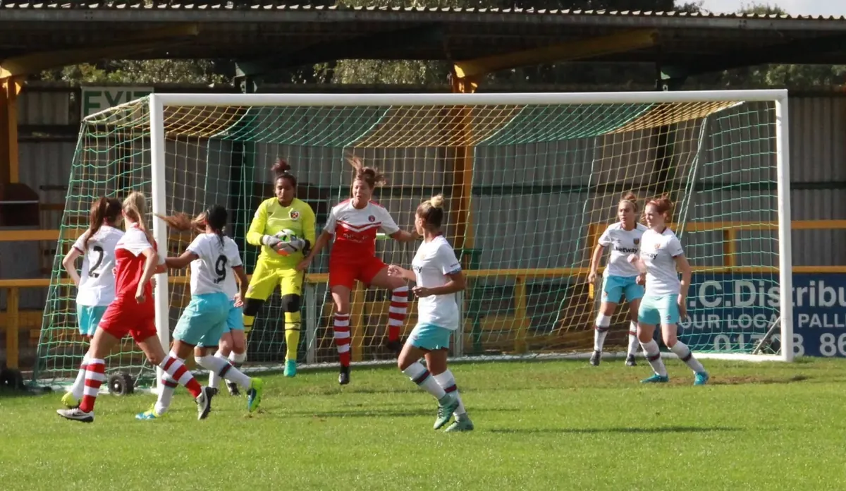 Aditi Chauhan claiming the ball in a crowded box during a West Ham United match.