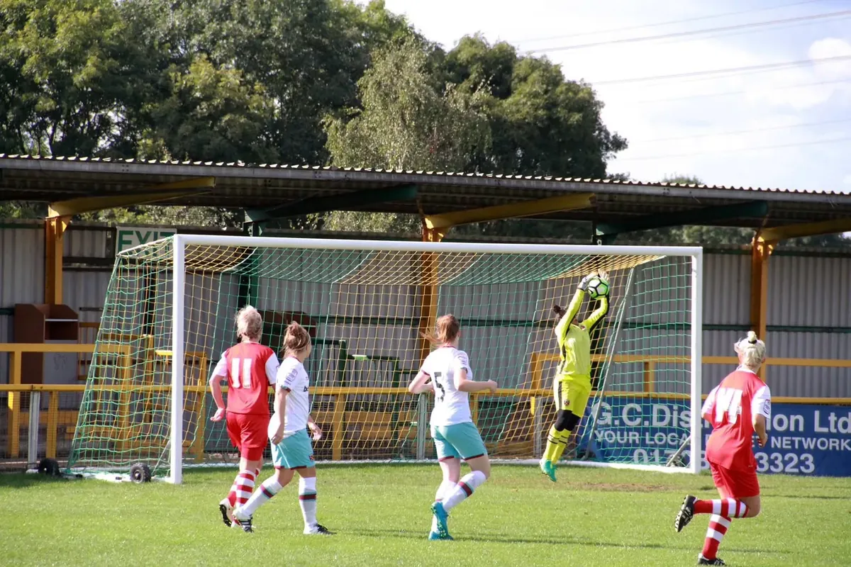 Aditi Chauhan making a leaping catch during a West Ham United match.